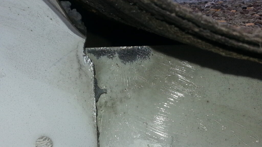 These tiny teeth marks on aluminum flashing help to identify this small gap as a mouse entry point.
