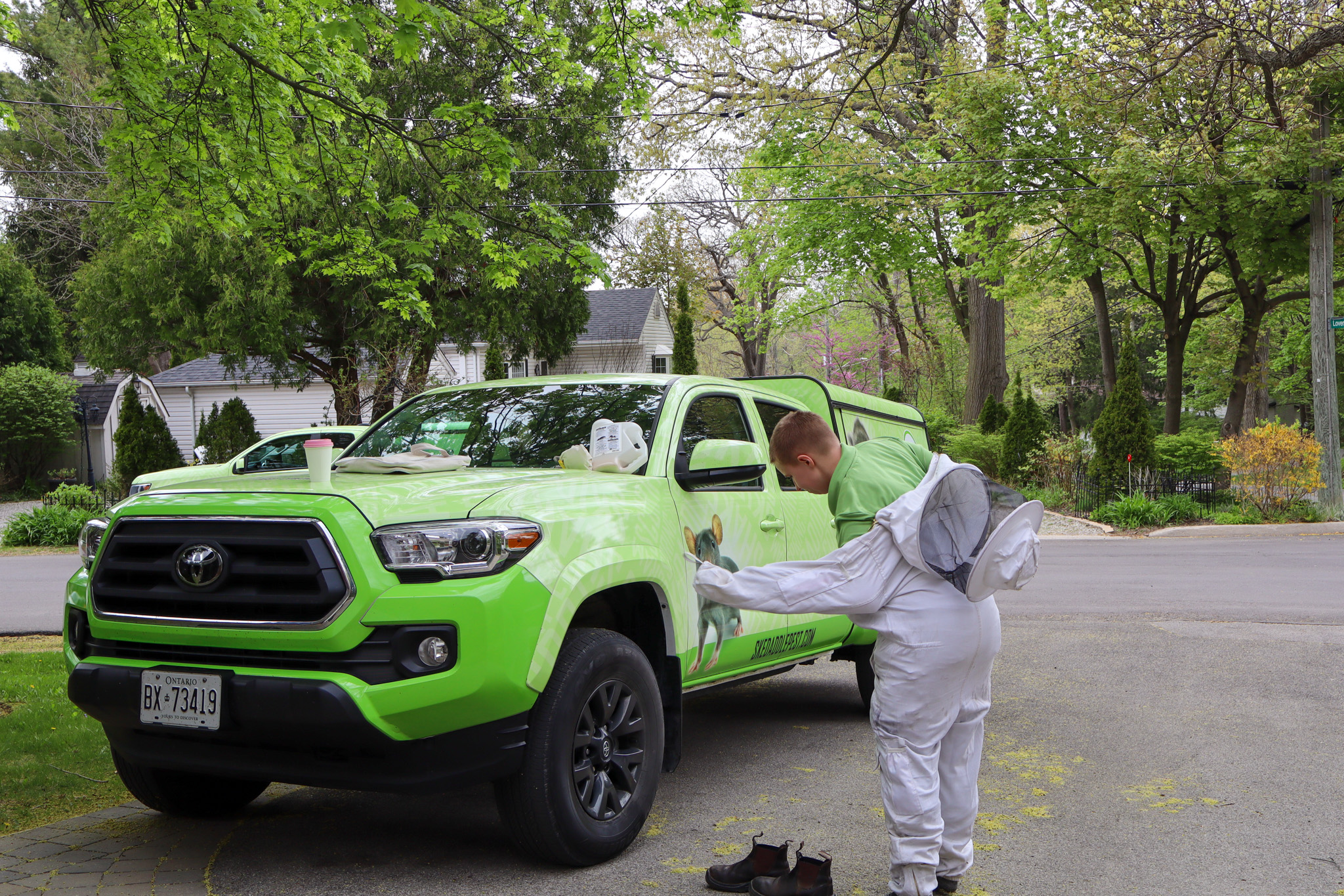 Skedaddle Technician Adjusting Gear by Branded Company Pickup Truck