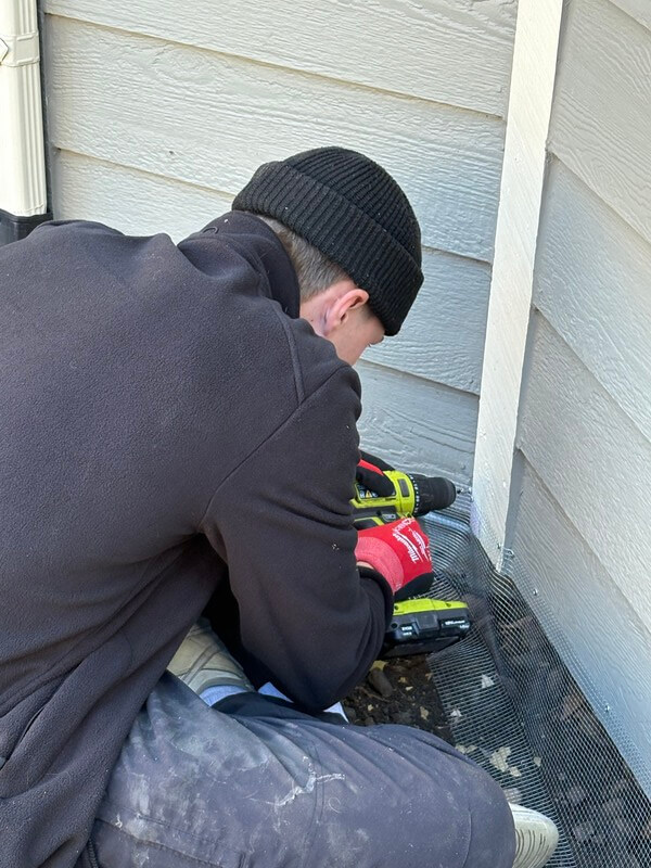 Denver Technicians secure screening on exterior or home Skedaddle humane wildlife control December 2025 3